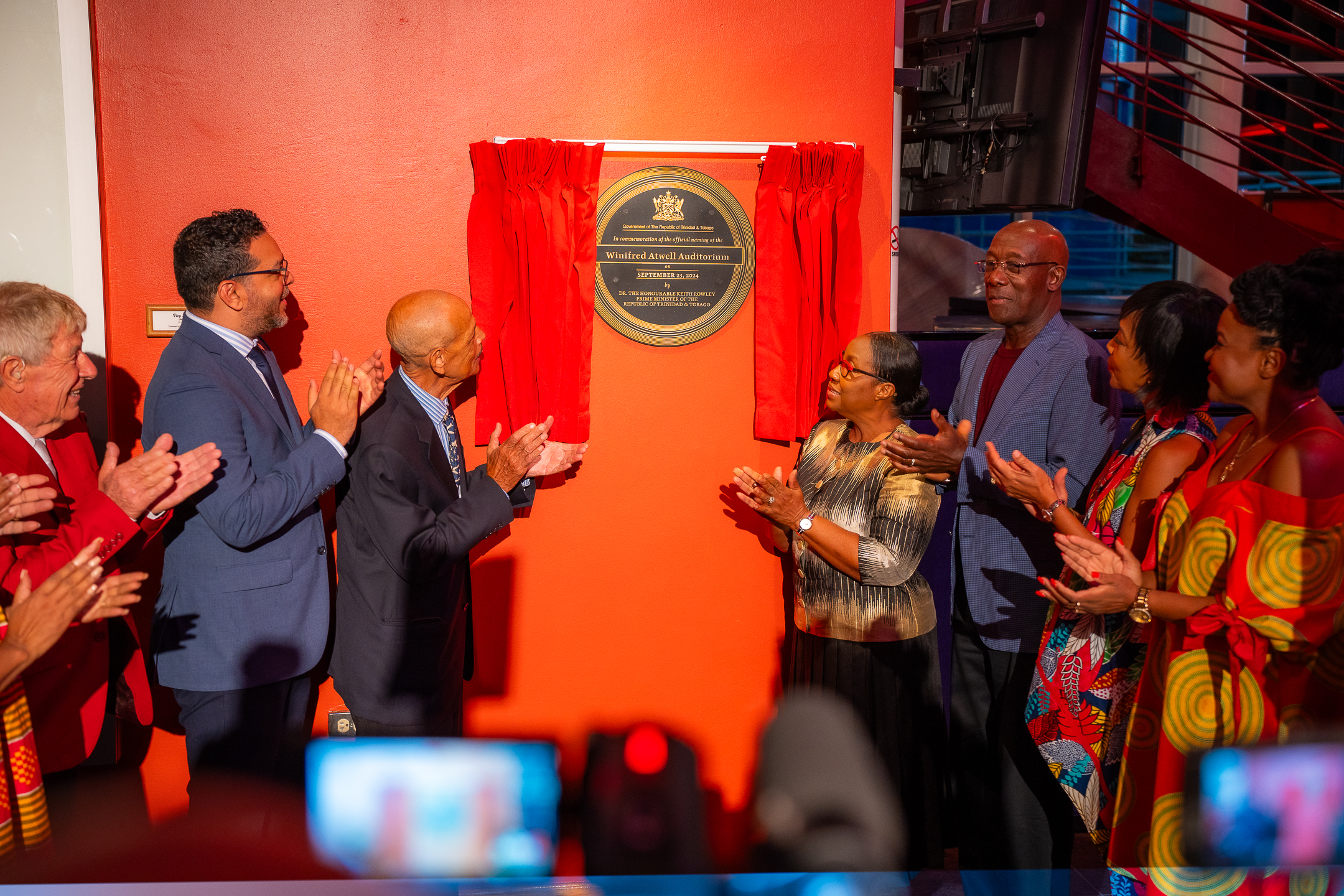 The unveiling of the Dedication Plaque and Building Signature at Queen's Hall's Winifred Atwell Auditorium Naming Ceremony. Photo credit: Stephen Dalchan