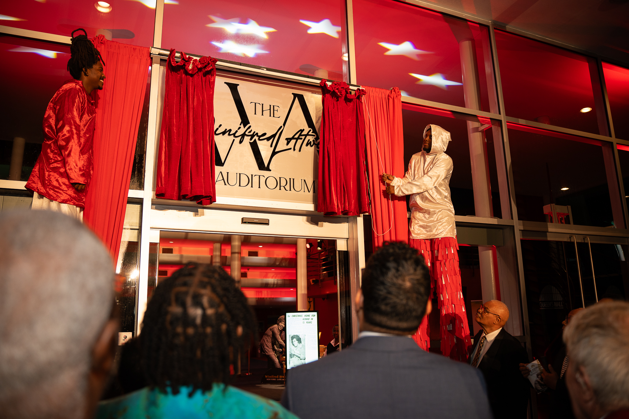 The unveiling of the Dedication Plaque and Building Signature at Queen's Hall's Winifred Atwell Auditorium Naming Ceremony. Photo credit: Stephen Dalchan
